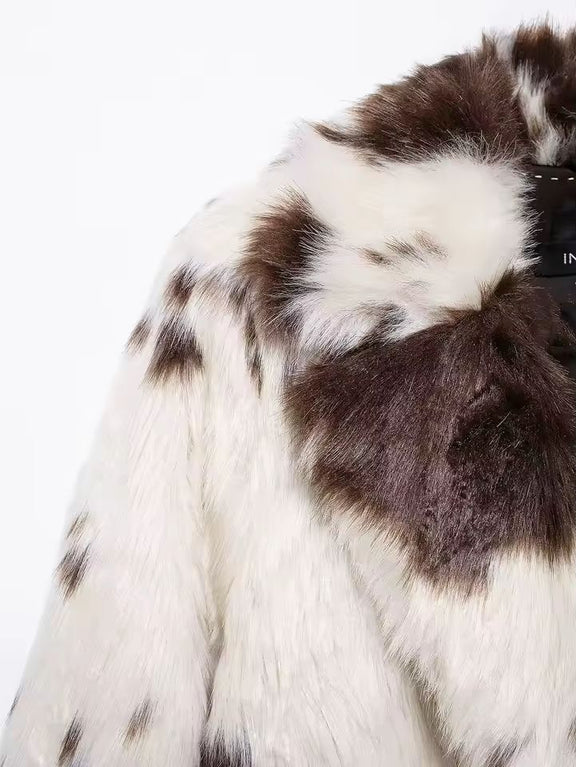 Close-up texture of soft brown and white faux fur material on women’s coat