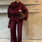 Stylish women's outfit: Oversized knitted set with V-neck pullover and comfortable wide-cut pants.